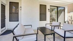 A covered patio with outdoor furniture, a sliding glass door, and a concrete floor. - Recently Remodeled Avondale Retreat, Private Yard! (Avondale)