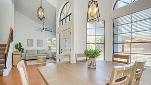 A dining area with a wooden table, chairs, and a potted plant. - Recently Remodeled Avondale Retreat, Private Yard! (Avondale)