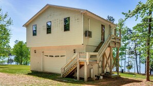 A two-story building with a garage, a staircase, and a view of the water. - 6 Mi to South Cove Boat Ramp! Lake Keowee Escape (Seneca)