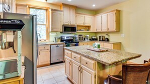 A kitchen with wooden cabinets, a stainless steel refrigerator, a microwave, and a dishwasher. - 6 Mi to South Cove Boat Ramp! Lake Keowee Escape (Seneca)