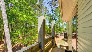 A wooden deck with a view of a forested area and a building with a sloped roof. - 6 Mi to South Cove Boat Ramp! Lake Keowee Escape (Seneca)