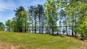 A grassy area with trees and a body of water. - 6 Mi to South Cove Boat Ramp! Lake Keowee Escape (Seneca)