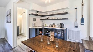 A modern kitchen with wooden countertops, a dining table with glasses, and a built-in oven. - Hot Tub, Pool, Dock: 2 Cabins Lakeview Grand Lake (Grove)