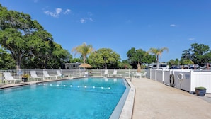 A swimming pool with lounge chairs, a white fence, and RVs parked nearby. - Pool Access! Spacious Home Near Wekiwa Springs (Apopka)