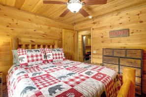 A wooden cabin interior with a bed, a ceiling fan, a dresser, and a sign that reads 'HUNT'. - Peaceful 2-cabin Property: 1 Mi to Current River! (Van Buren)