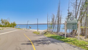 A road leading to a body of water with a sign indicating a boat launch area. - Walk to the Beach! Boyne City Escape w/ Lake Views (Boyne City)
