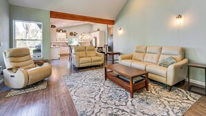 A spacious living room with a large sofa, a recliner, and a coffee table. - Private Beach & Hot Tub! Family Gem on Puget Sound (Shelton)