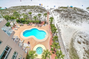 A pool area with lounge chairs, a small pool, and a beach with umbrellas. - Remodeled🌴🌴Beachfront🌊🌊Sunset View☀️☀️8th Floor⛱️⛱️Destin Towers (Destin)