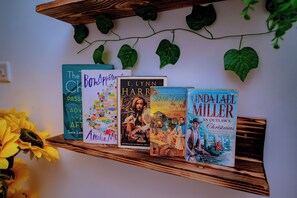 Ein Bücherregal aus Holz mit Büchern und einer Sonnenblume.