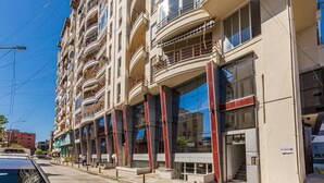 Un edificio a più piani con balconi, ampie finestre e un ingresso ben visibile.