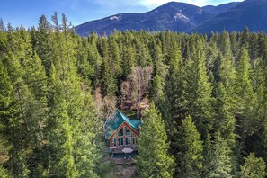Exterior - Peaceful Escape by the Water. Relax with the whole family at this peaceful place to stay. Tucked in the woods with breathtaking views of the river. Fire pit, large deck, river access and so much more! (Hungry Horse)