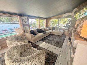 Living area - Coastal Pearl | Walk to Beach | Heated Pool + Hot Tub | 4BR Family Retreat (Holmes Beach)