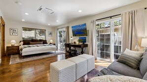 A bedroom with a bed, a desk, a computer, and a large window. - The “Pine Tree Cabin”. Hot Tub, 4Br, 2 Ba, A/C, Near beaches, casinos, skiing (Stateline)