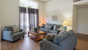 A living room with two sofas, a coffee table, and two lamps. - Family 3BR Near Disney | Pool & Fenced Yard (Kissimmee)
