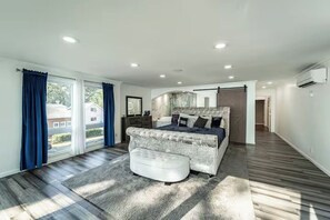A modern bedroom with a large bed, a bench, and a view through the window. - The Bachelorette- Wake up to waves live in luxury Your East Coast escape awaits. (North Beach)
