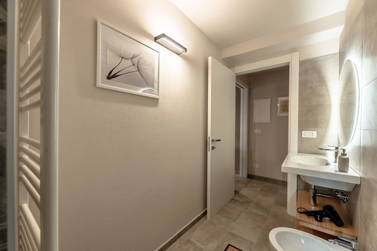 A modern bathroom with a toilet, bidet, and sink.