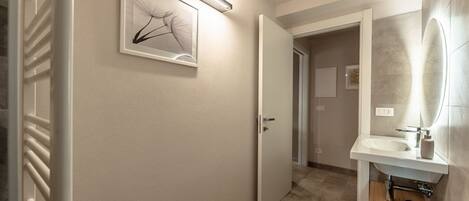 A modern bathroom with a toilet, bidet, and sink.