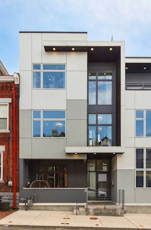 A modern building with multiple windows, a flat roof, and a visible entrance. - Rooftop Sauna + Hot Tub | Spa Room | Cabana! (Pittsburgh)