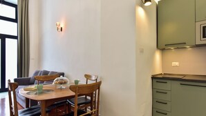 Un coin repas comprenant une table, des chaises, un livre, une tasse et un petit objet décoratif.