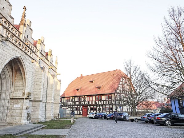 A historic building with a red-tiled roof and a stone facade.
