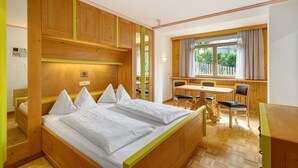 A room with a bed, a desk, and a window. - Apartment '6 Residence Ciasa Ulli Typ A' with Mountain View, Shared Terrace and Wi-Fi (San Cassiano)