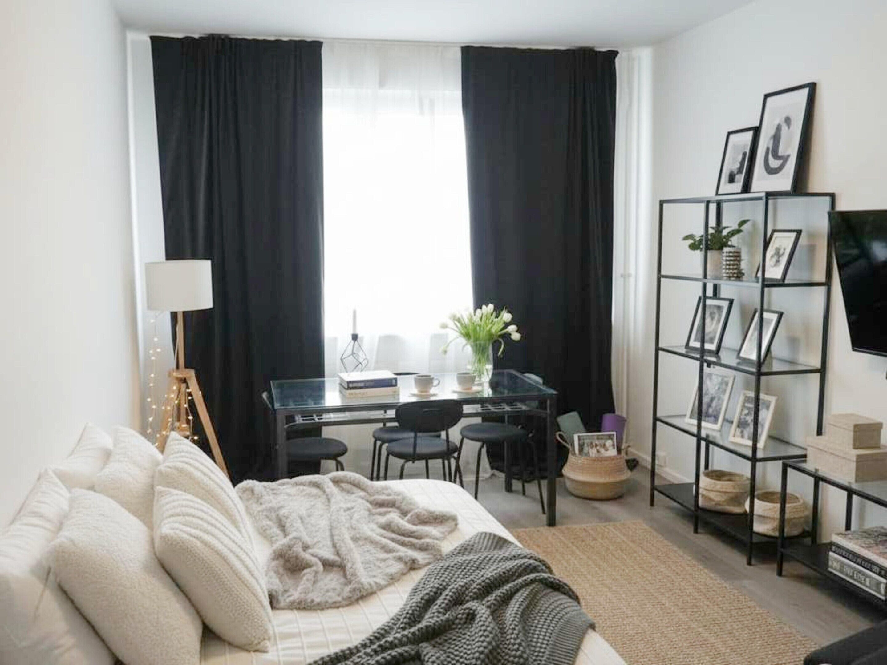 A modern living room with a sofa, a coffee table, a desk, and a TV.