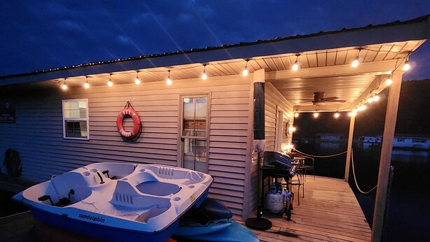 A covered outdoor area with a boat, a lifebuoy, and a gas tank.