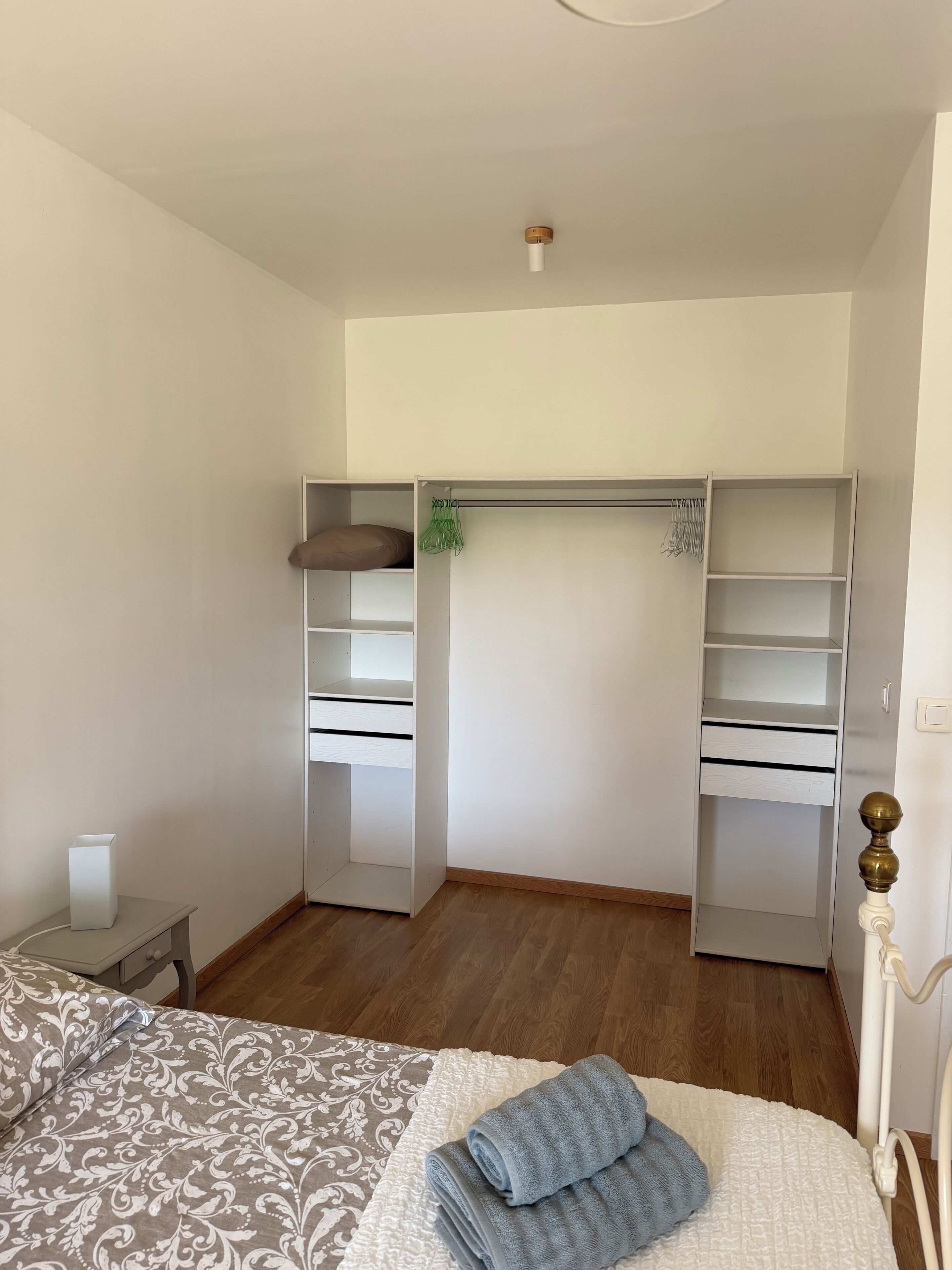 Une chambre à coucher comprenant un lit, une table de chevet, une armoire et une commode.