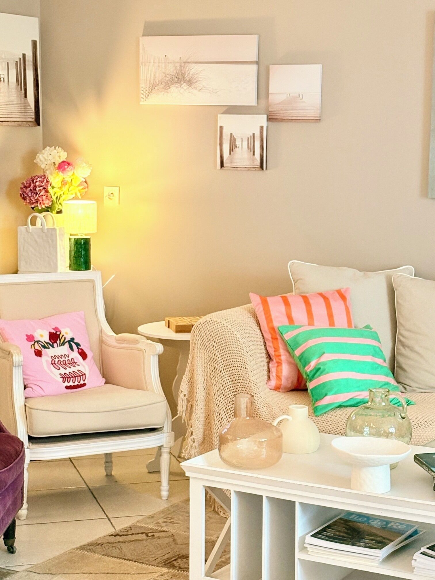 A cozy living room with a sofa, armchair, and a small table with decorative items.