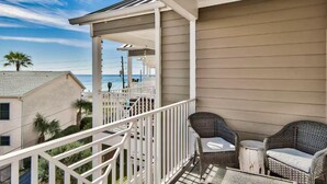A balcony with wicker furniture, a railing, and a view of the ocean. - ☀️100 feet to Beach | Pool | Multiple Balconies and Patio | Beach Pointe 203☀️ (Destin)