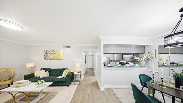 A modern living room with a green sofa, a coffee table, and a dining area with a table and chairs. - Newly furnished  • 3mins to Galleria  •Uptown Houston •King & Queen (Houston)