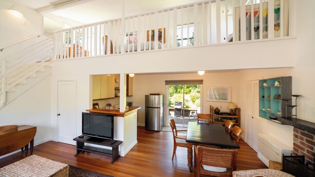 A spacious living area with a staircase, a kitchen, and a dining area. - Hideaway in Quiet Bolinas Near the Beach (Bolinas)