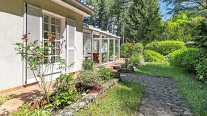 A house with a stone pathway leading to a covered patio area. - Holiday Home with Park, Private Pool, Wi-Fi, and Air Conditioning in Jaujac (Jaujac)