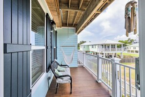 A porch with a hammock, a bench, and a view of houses. - Chill Days, Fun Nights near Downtown Bay St. Louis. (Bay St. Louis)
