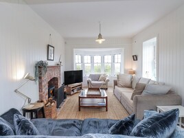 A living room with a fireplace, television, and seating area.
