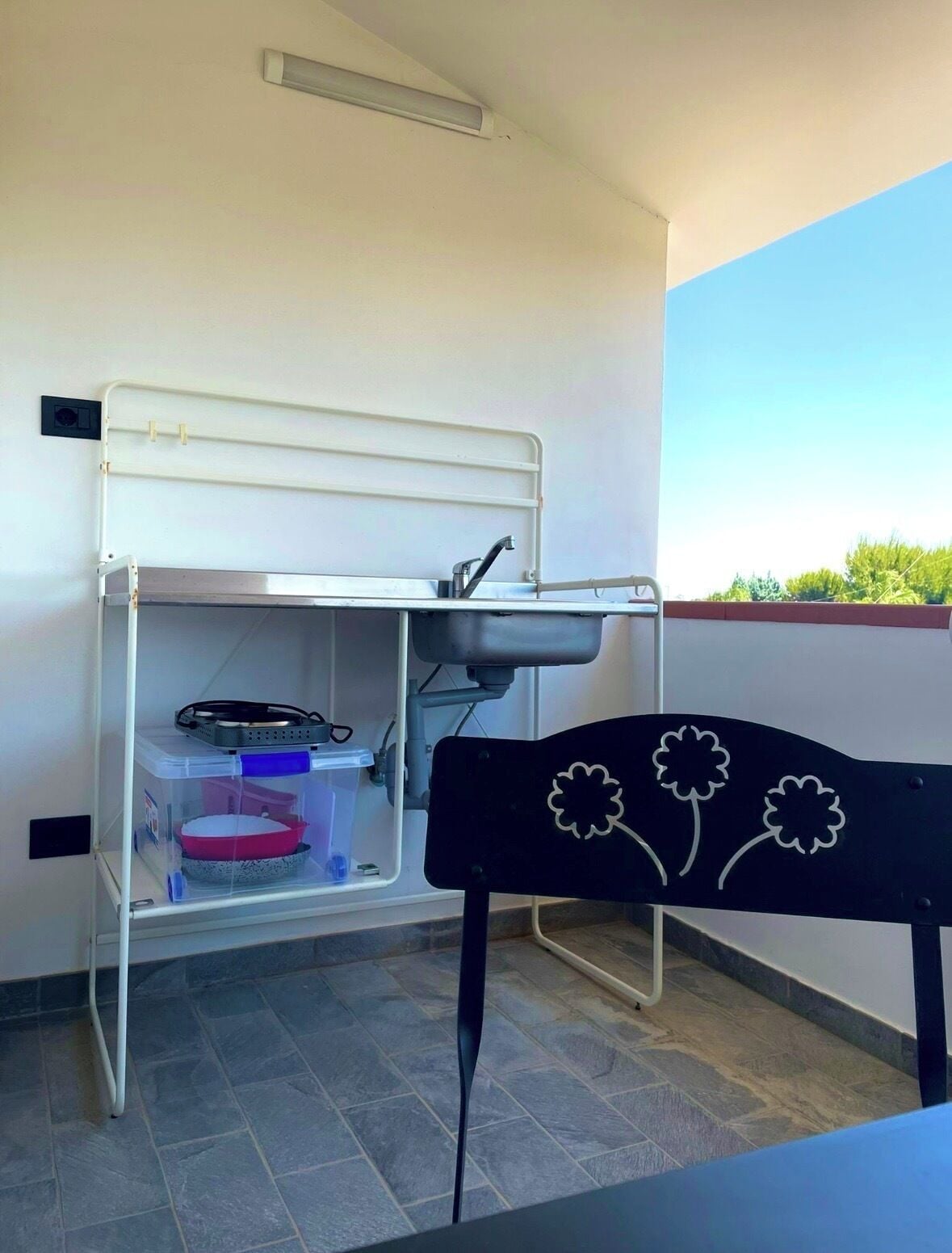A compact room with a bunk bed, a desk with a chair, and a small window.