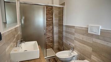 Shower, hair dryer, towels, toilet paper