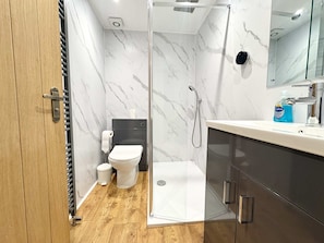 A modern bathroom with a shower, toilet, and vanity. - Prime York City Centre Flat Near Station (York)