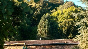 A rustic stone building with a tiled roof, a swing set, and outdoor seating. - Gîte De La Fontaine – Entire Property, Sleeps 13, Les Cammazes (Les Cammazes)