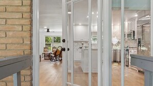 A view through a glass door into a kitchen with white cabinets and a wooden floor. - Perfect 3bedroom house in Colleyville, Proximity Sabre, Charles Schwab, Fidelity (Colleyville)