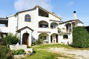 A two-story house with a patio, a stone staircase, and a well-maintained garden. - Elegant Living for Your Vacation (Umag)
