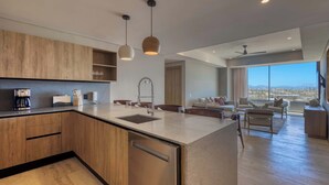 A modern kitchen with wooden cabinets, a built-in dishwasher, and pendant lighting. - Punto Nima: Panoramic PH with Private Terrace (San José del Cabo)
