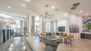 A modern indoor space with a foosball table, a pool table, and a bar area. - Peaceful Remodeled Unit | Serene Wellness Retreat (Scottsdale)