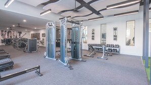 A modern gym with treadmills, weight machines, and dumbbells. - Peaceful Remodeled Unit | Serene Wellness Retreat (Scottsdale)