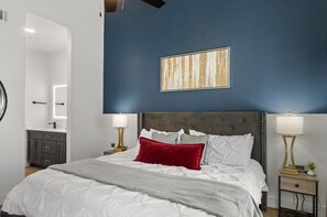 A bedroom with a bed, nightstands, a mirror, and a wall-mounted artwork. - Near TPC|Heated Pool| Near Shops | Dine | Museums (Scottsdale)
