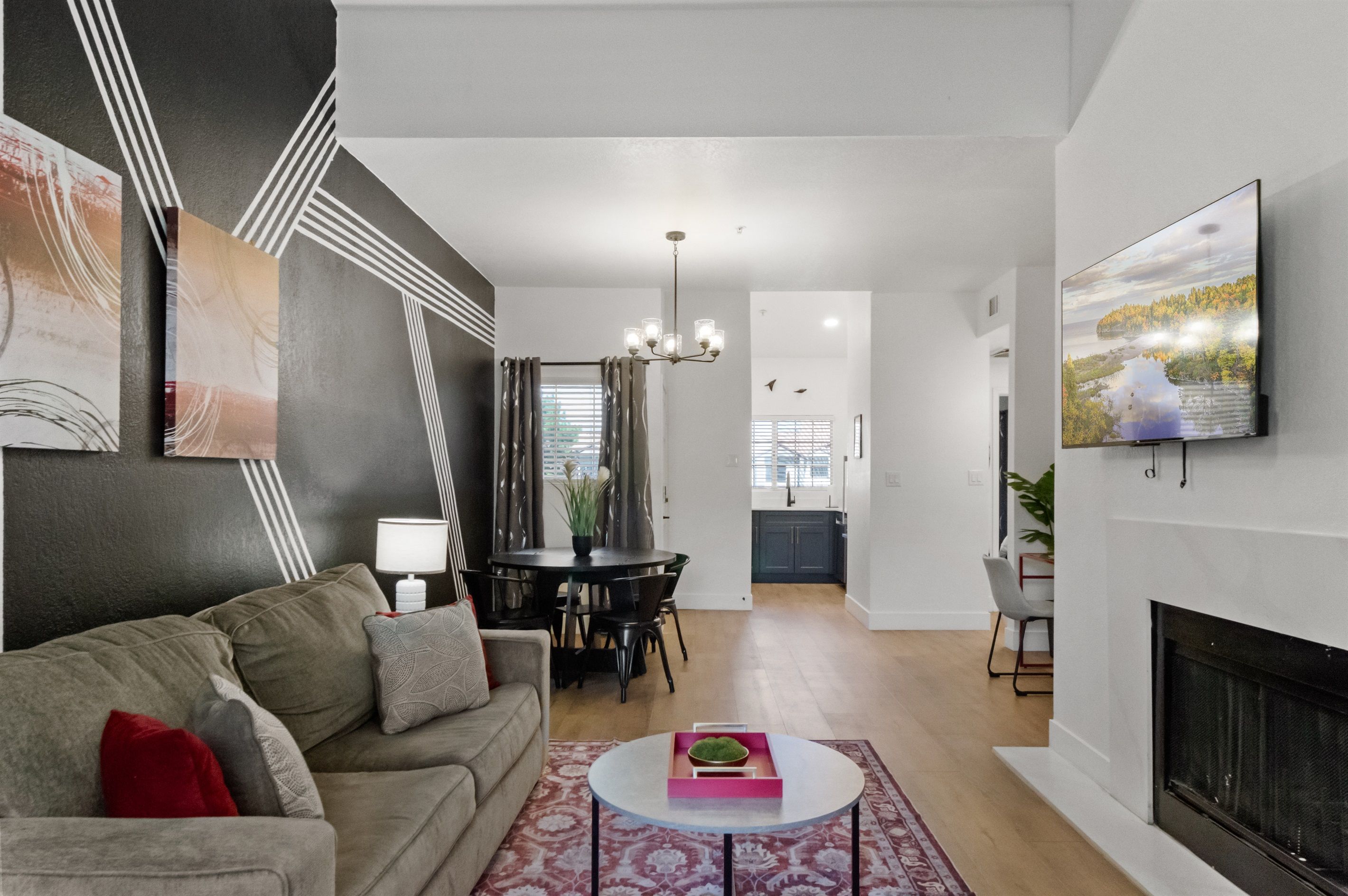 Una sala de estar moderna con un sofá, una mesa de comedor y una chimenea.