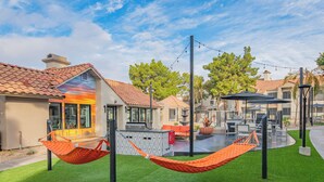 A residential area with houses, a patio with outdoor furniture, and a hammock. - Upscale Gourmet Retreat | Fully Stocked Kitchen (Scottsdale)