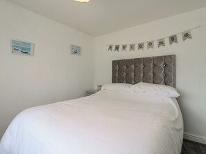 A bedroom with a large bed, a headboard, and a welcome banner. - 38 St Margarets (Dover)