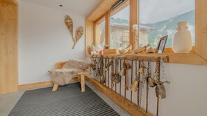Une pièce chaleureuse avec un banc en bois, une décoration rustique et une vue sur les montagnes.