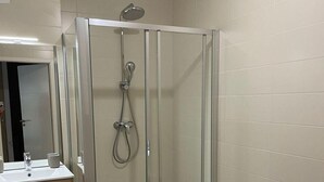A bathroom with a glass-enclosed shower, a vanity with a mirror, and a toilet. - 200m from ski slopes, 1st floor, terrace, tv, ski locker, 38m², Saint Gervais (Saint-Gervais-les-Bains)